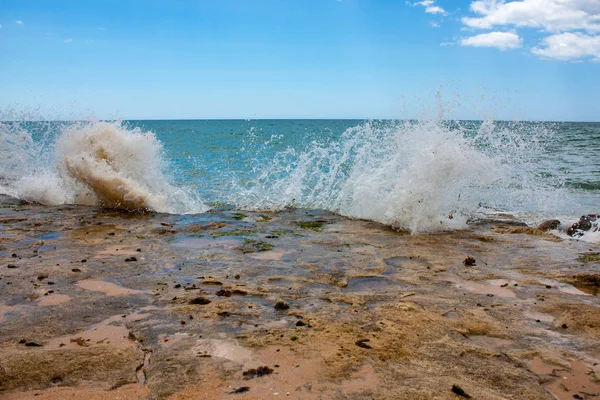 Dalgalar kayaların üzerine kırma