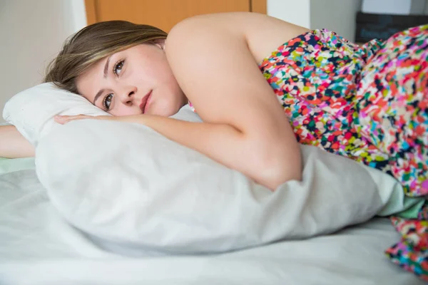 Onu yatakta yatan ciddi genç kadın