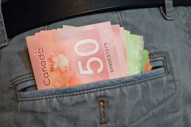 Canadian dollars in jeans pocket clipart