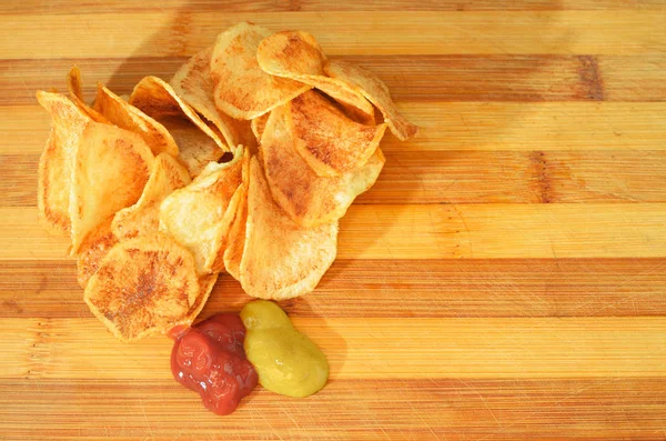 Portion of fried rounded potato with ketchup and mustard — Stock Photo, Image