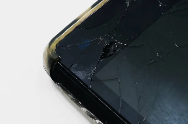 Upper corner of a smartphone with the glass broken of the screen
