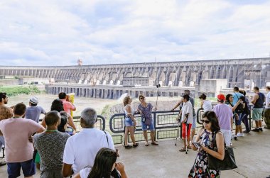 Tourists taking photos of the Itaipu dam clipart