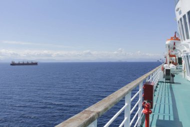 Geminin uzun güvertesi, güzel bir manzara ve denize doğru sürüklenen kocaman bir tanker..