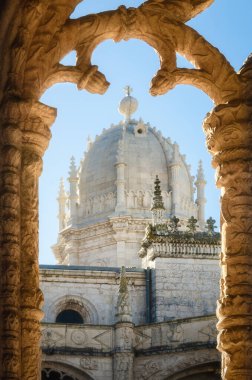 LISBON, PORTUGAL - 3 Şubat 2019: 3 Şubat 2019 'da Portekiz, Lizbon' daki Jeronimos manastırının kemerlerine çerçevelenmiş Belem Kilisesi 'nin Santa Maria kulesi ve çan kulesi