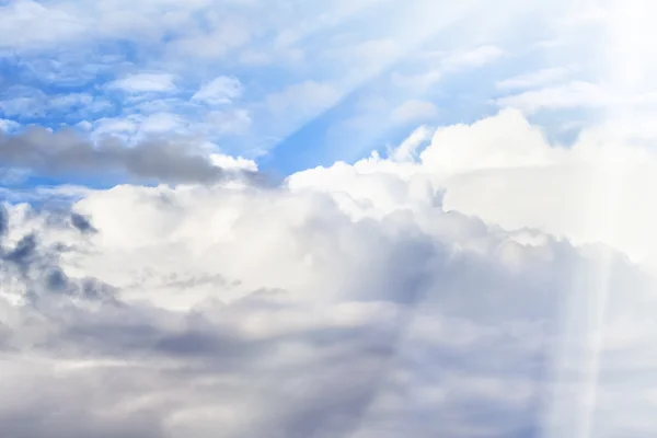 Epic blue sky with white fluffy clouds and sun. Sunny day