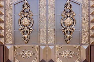 Old forged decorative gates decorated by golden ornament. clipart