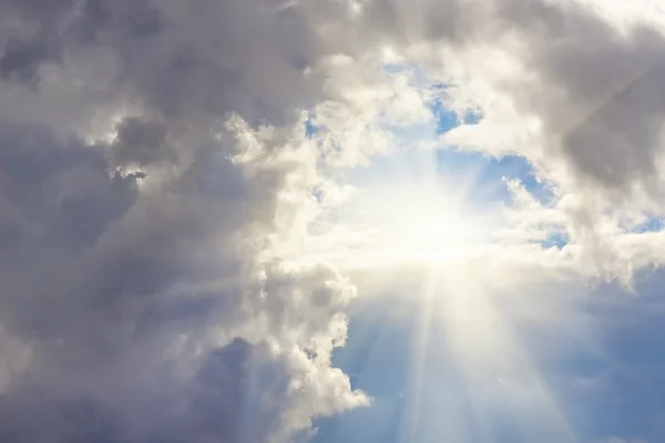 Cloudy sky with columns clouds and sun Stock Photo