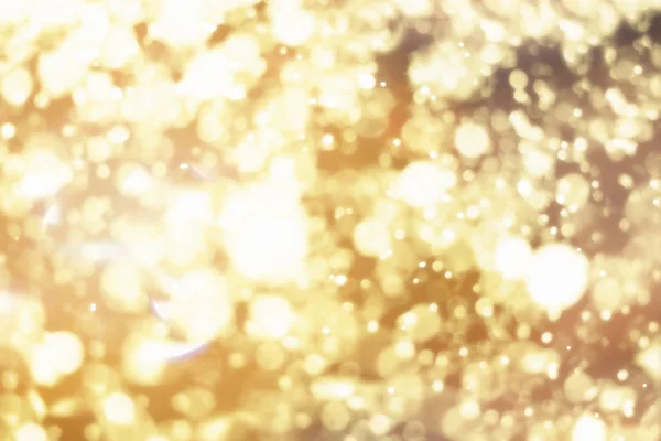 Golden sfondo astratto di Natale. Luci festive bokeh o glitter — Foto Stock