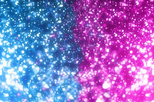 Abstract intreepupil deeltjes of glitter lichten. Blauwe en roze bokeh. Kerstmis achtergrond — Stockfoto