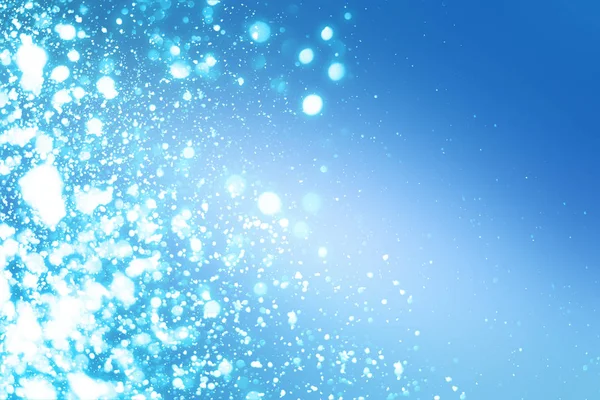 Navidad abstracta bokeh luces de brillo sobre fondo azul. Partículas de círculo desenfocadas redondas —  Fotos de Stock