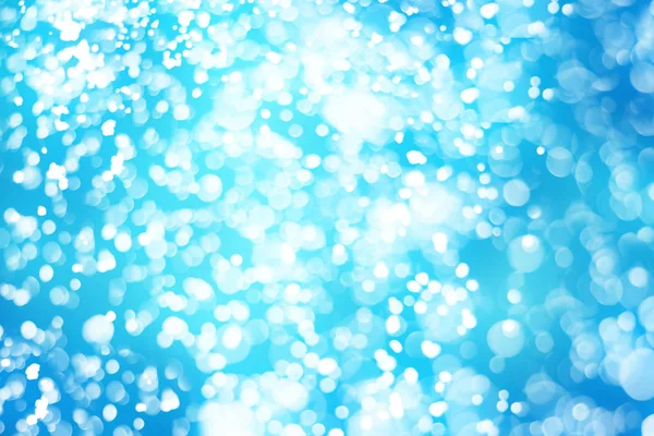 Χριστουγεννιάτικα φώτα γκλίτερ αφηρημένη bokeh σε μπλε φόντο. Κύκλος γύρω από defocused σωματίδια — Φωτογραφία Αρχείου