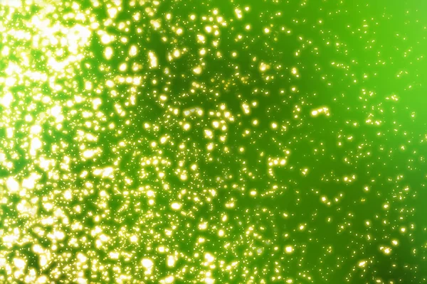 Green festive background with golden glitter bokeh lights — Stock Photo, Image