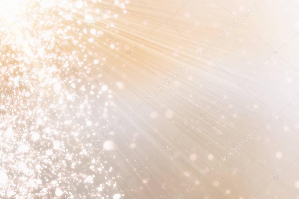 Warm golden background with bokeh or glitter and sun rays