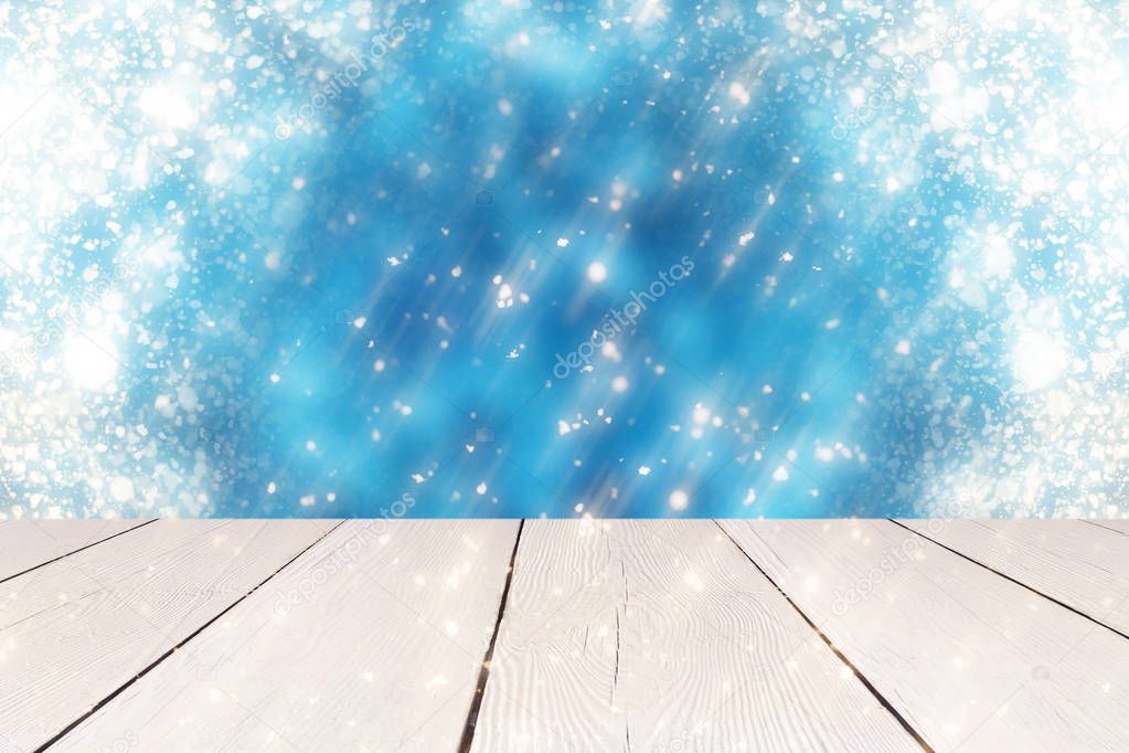Christmas abstract blue background with golden round bokeh or circle glitter lights  and white table. Use  for display or montage your products