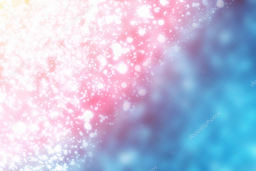 Christmas abstract bokeh glitter lights on blue background. Round defocused circle particles