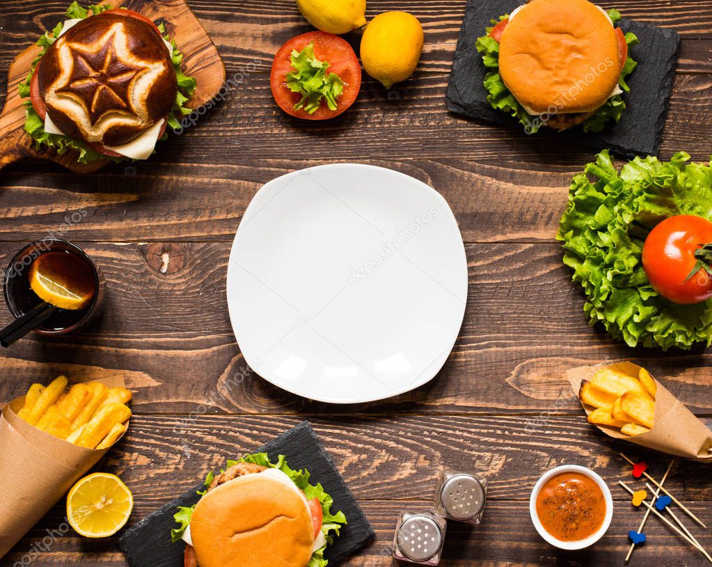 Top view of delicious hamburger, with vegetables,  on a wooden b