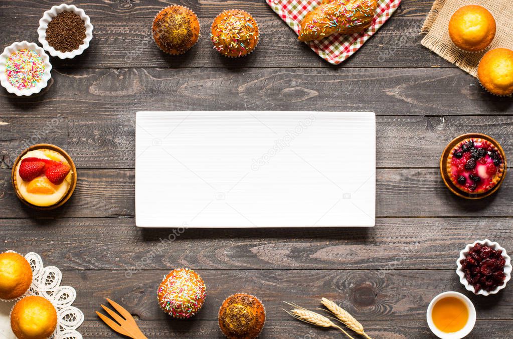 Delicious homemade muffins with yogurt, on a wooden background w