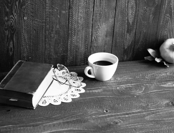 Old vintage telephone, coffee, book, on a wooden background,
