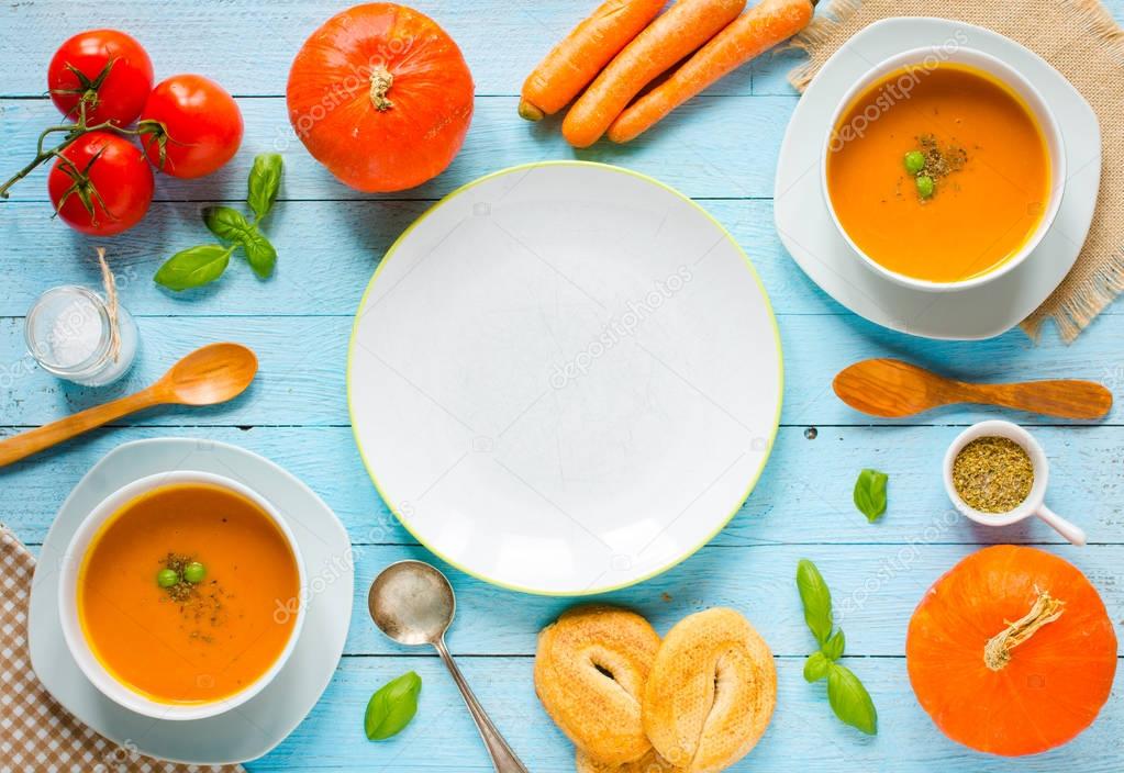 Homemade Pumpkin Soup on rustic wooden background, free space fo