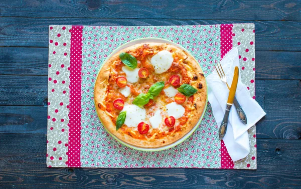 Top view of italian classic pizza margherita over a wooden table