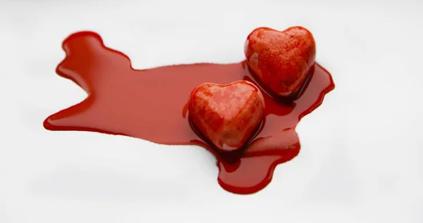 Two Red Hearts Red Paint Blood Stock Photo