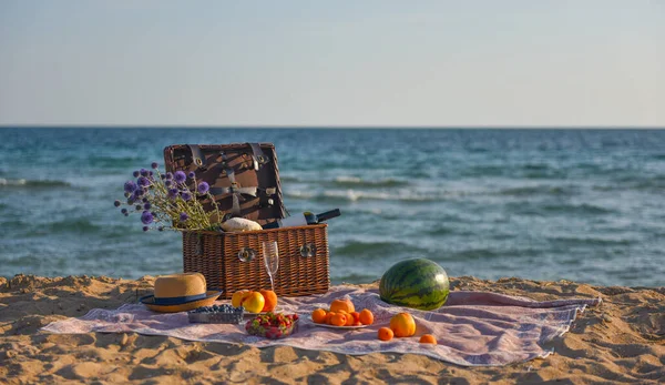 picnic basket wine fruit by the sea