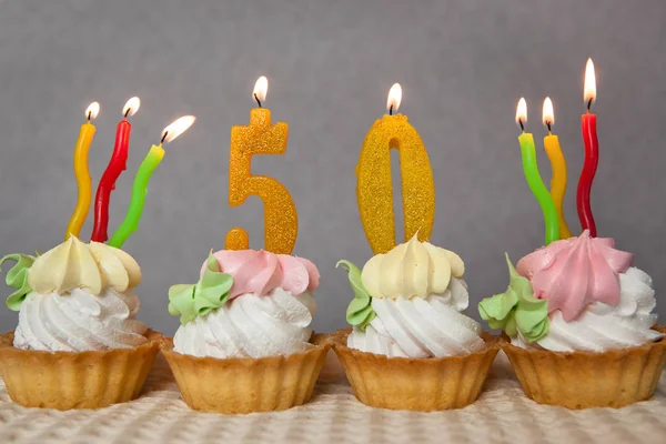 Aniversario de cumpleaños 50 años con pasteles y velas de oro — Foto de Stock