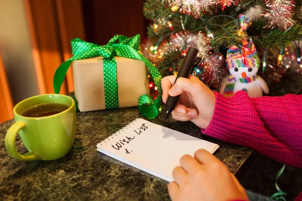 Woman writing wish list, happy new year concept