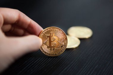 Siyah arka plan, kripto para birimi kavramı üzerine elinde Bitcoin