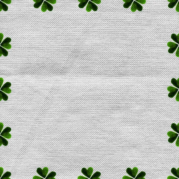 Green clover border, frame on linen fabric canvas background. — Stock Photo, Image