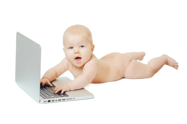 Child sits in front of a laptop and push buttons — Stock Photo, Image