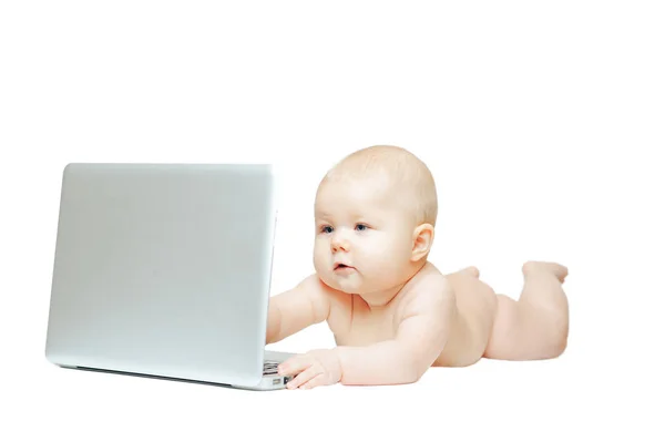 Child sits in front of a laptop and push buttons — Stock Photo, Image