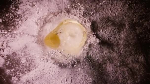 Slow motion video of a drop of egg yolk to the flour 240 fps — Stock Video