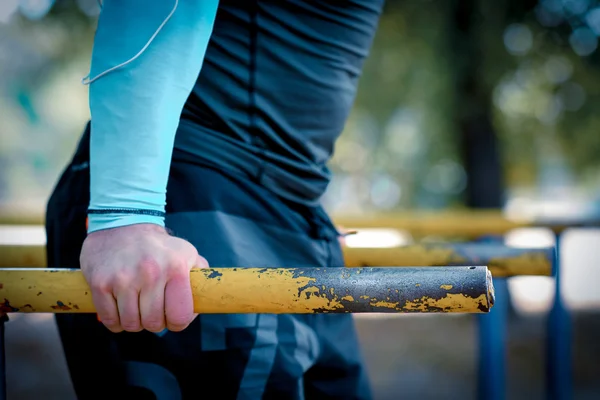 Man doing exercises on parallel bars — Stock Image Man doing exercises on parallel bars Stock Picture
