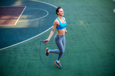 Attractive woman jumping rope clipart