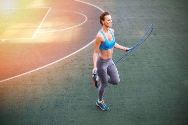Sporty woman with skipping rope 