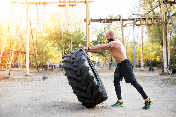 sportsman exercising with tire