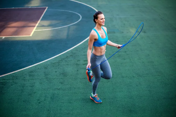 Muscular woman using jump rope — Stock Photo