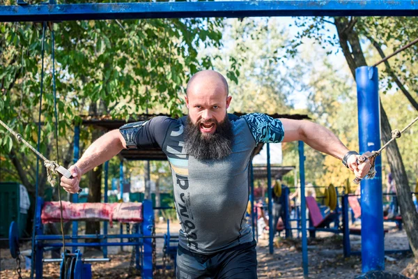 Man doing exercises with weights — Stock Photo