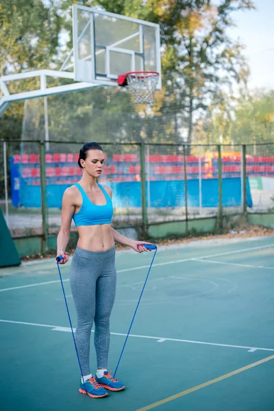 Woman working out with skipping rope — Stock Photo