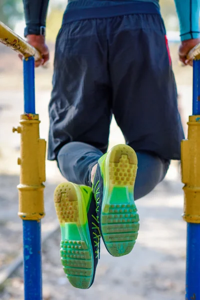 Muscular man on parallel bars — Stock Photo