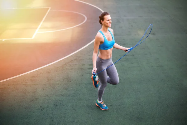 Sporty woman with skipping rope — Stock Photo