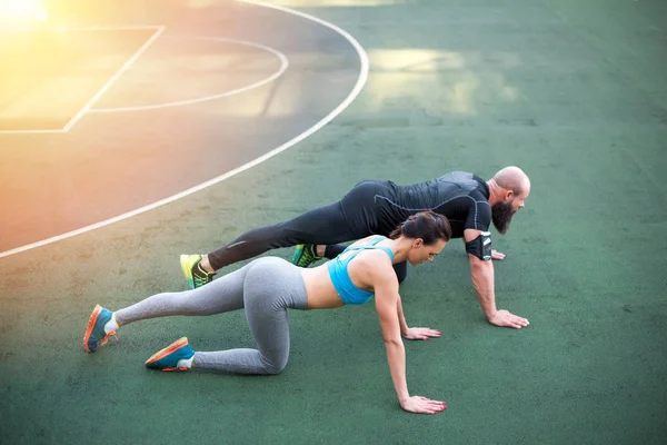 Couple exercising on stadium — Stock Photo