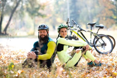 cyclists resting near bicycles 