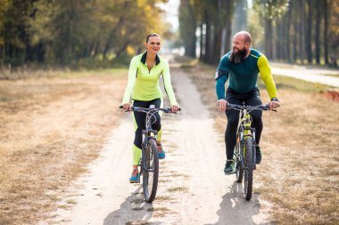 Couple cycling outdoors clipart