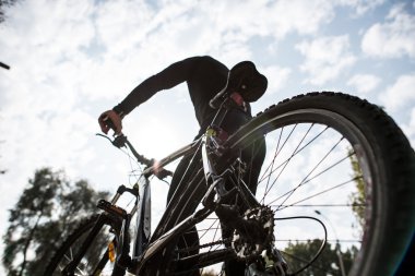 Rear view of man with bicycle clipart