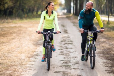 Couple cycling outdoors clipart