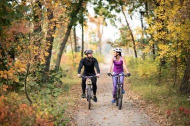 Couple cycling outdoors clipart