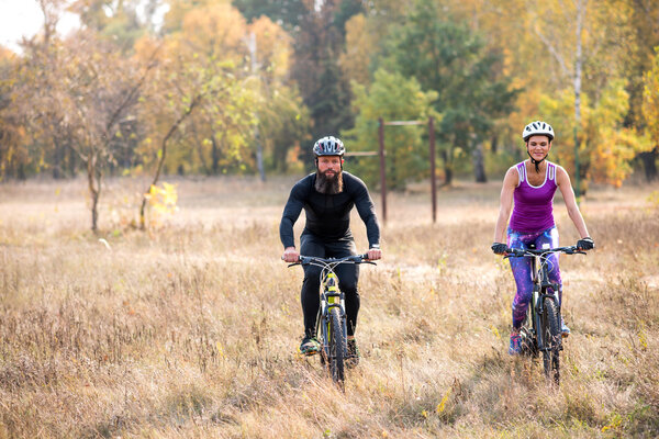 Couple cycling outdoors