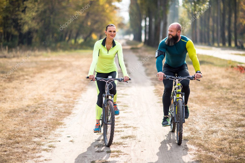 Couple cycling outdoors